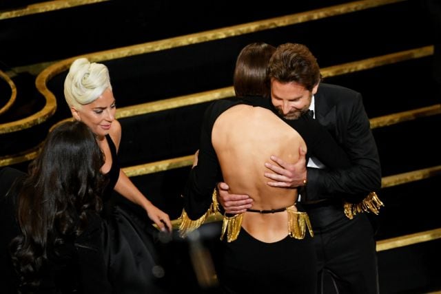 Abrazos entre Bradley Cooper, Lady Gaga e Irina Shayk tras ganar un Oscar.