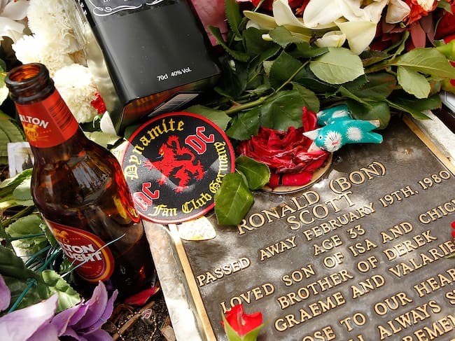 PERTH, AUSTRALIA - FEBRUARY 19: Tributes adorn the memorial of Bon Scott on the 30th anniversary of AC/DC's former frontman's death, at Fremantle cemetery on February 19, 2010 in Perth, Australia. Scott died at the age of 33 in London from alcohol poisoning and was found in his car, where he initially fell asleep. AC/DC are currently touring Australia with their "Black Ice" tour, their first tour here since 2001. (Photo by Paul Kane/Getty Images)