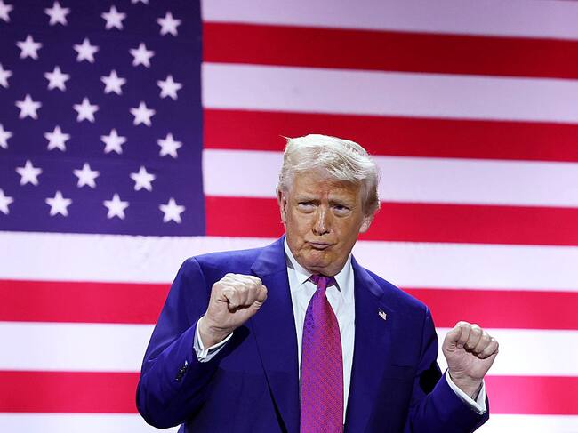 DOHA, QATAR - MAY 15: U.S. President Donald J. Trump gestures on stage as he tours the Al Udeid Air Base on May 15, 2025, in Doha, Qatar. Trump is on the third day of his visit to the Gulf to underscore the strategic partnership between the United States and Qatar, focusing on regional security and economic collaboration. (Photo by Win McNamee/Getty Images)