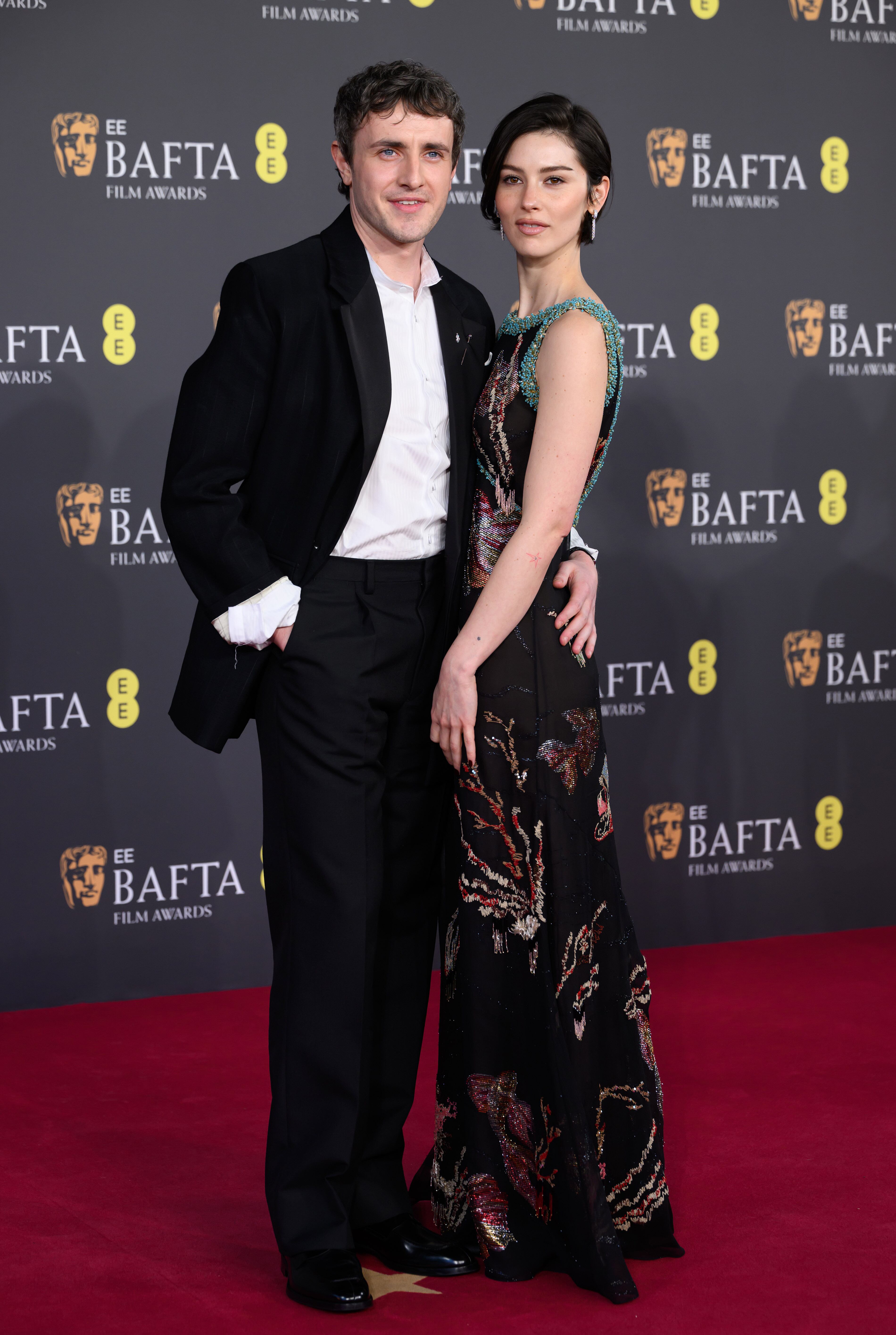 El protagonista de Hamnet y su novia, la cantante Gracie Abrams posaron así de cómplices. él escogió un traje de Prada y ella, un vestido de Chanel.