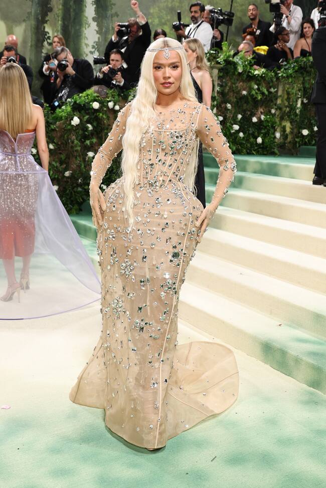 La esperábamos y llegó. Karol G hizo su debut en la MET Gala convertida en elfa con un diseño de Marc Jacobs en el que las transparencias y los volúmenes que con el dorado como protagonista se unían a la pedrería y la sensualidad de la gasa que convertían a la colombiana en una auténtica hada del bosque con orejas de elfa incluidas.
