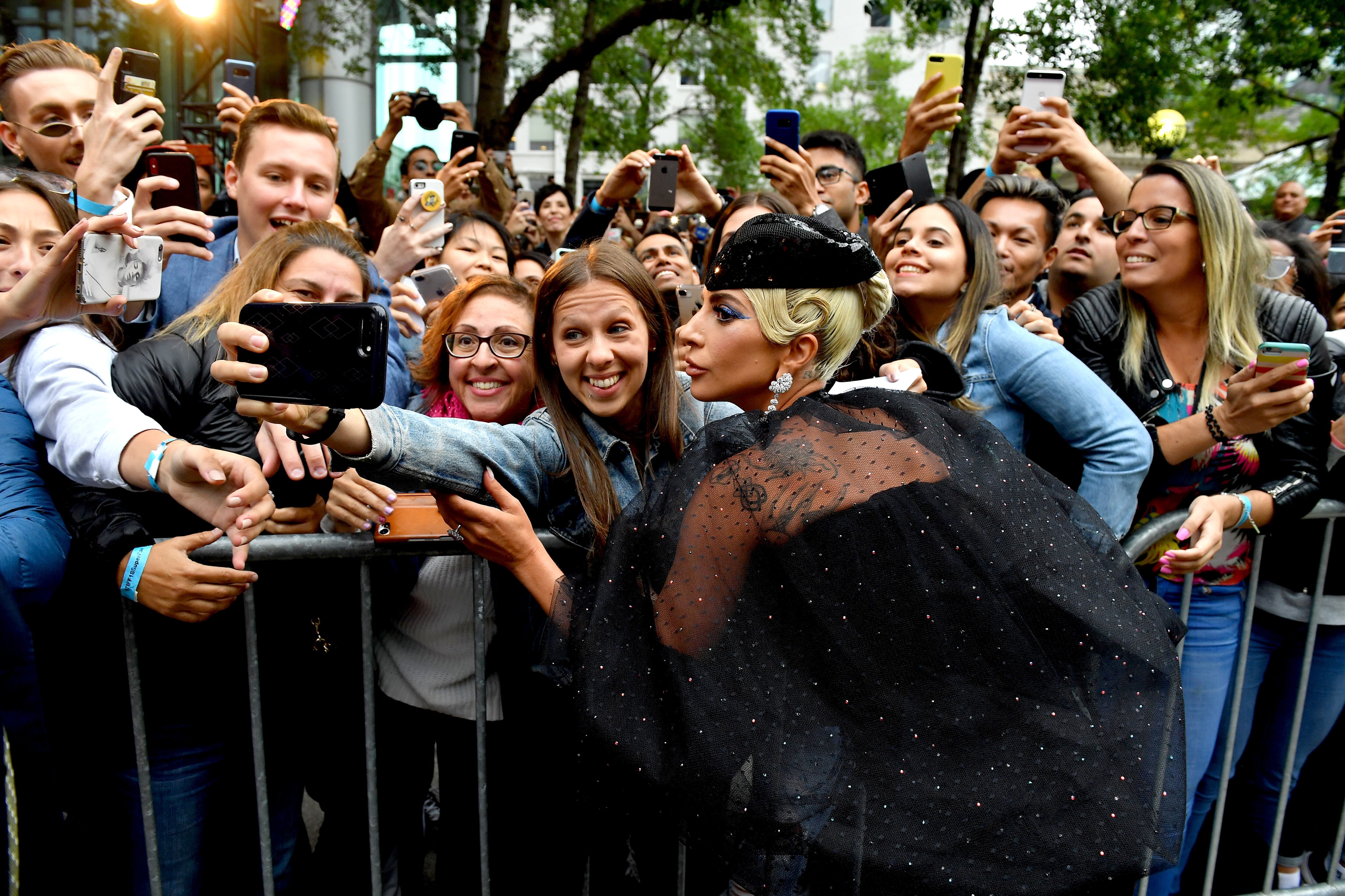 TORONTO, ON - SEPTEMBER 09:  Lady Gaga interacts with fans as she attends the &quot;A Star Is Born&quot; premiere during 2018 Toronto International Film Festival at Roy Thomson Hall on September 9, 2018 in Toronto, Canada.  (Photo by George Pimentel/Getty Images for TIFF,)