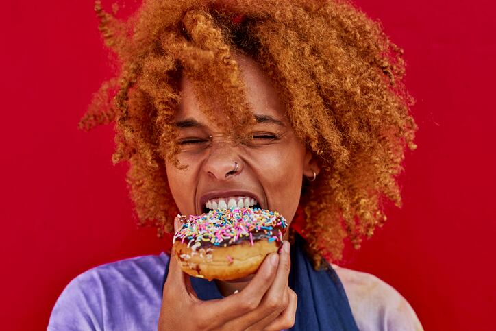 Portrait of woman eating a donut