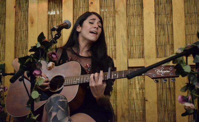 Bely, acompañada de su guitarra en el concierto