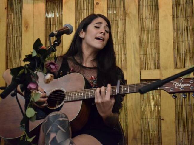 Bely, acompañada de su guitarra en el concierto