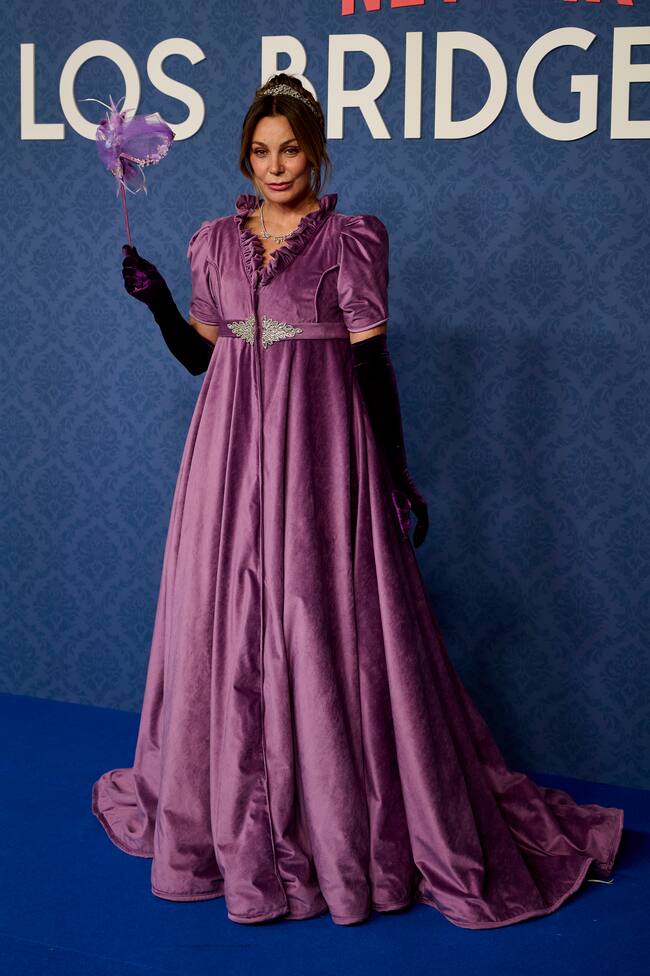 Nuestra querida Mar Flores bien podría ser la amiga de la Reina Carlota. Menudo abrigo que llevaba en color morado. Metida de lleno en el papel y con sorpresa debajo.